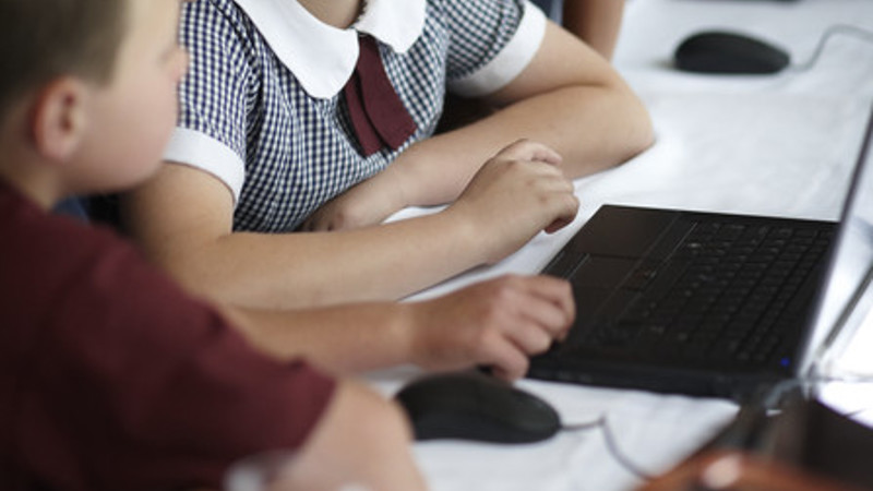 Students gathered around a computer