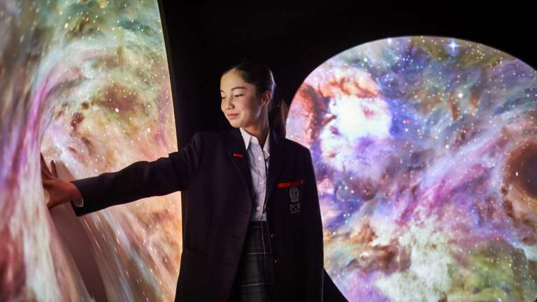 Schoolgirl interacting with science display