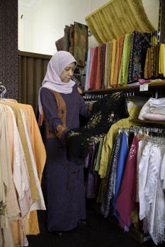 Woman holding piece of clothing