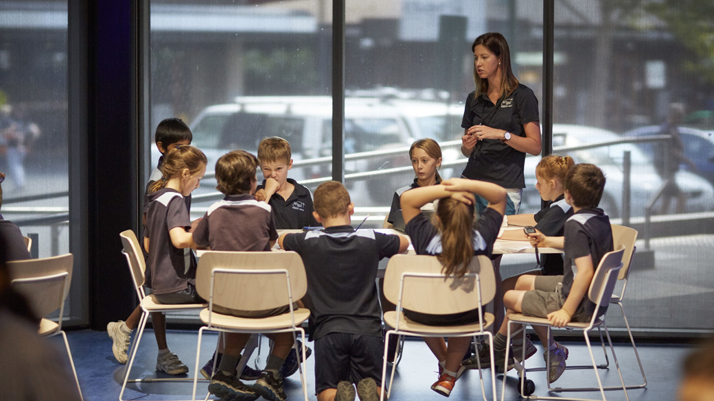 Teacher and students at a table