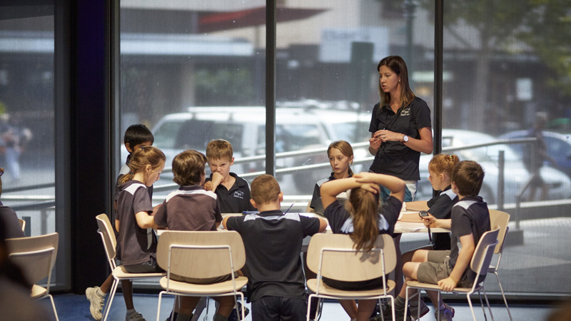 Teacher and students at a table