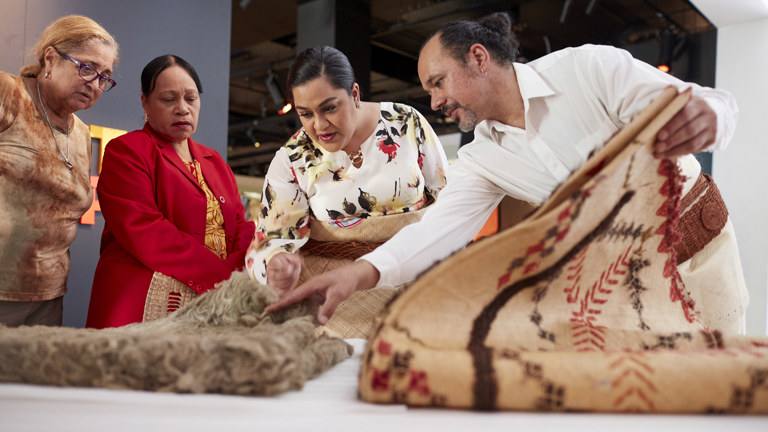 Four people looking at collection objects