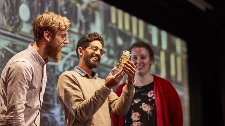 Promotional shot of museum staff presenting a lecture.