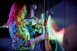Woman interacting with museum installation