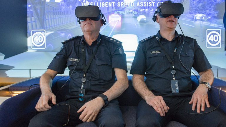 Two police officers with VR headsets on