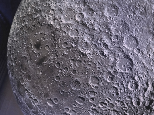 A close up view of the moon sculpture, showing craters and other geological features present on the moon surface.