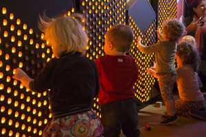 Children interacting with the Light Wall exhibit in the Ground Up exhibition