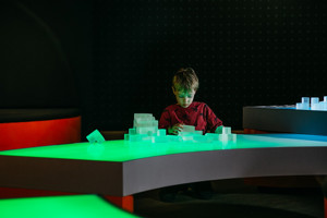 Child playing with Light Table blocks in the Ground Up exhibition