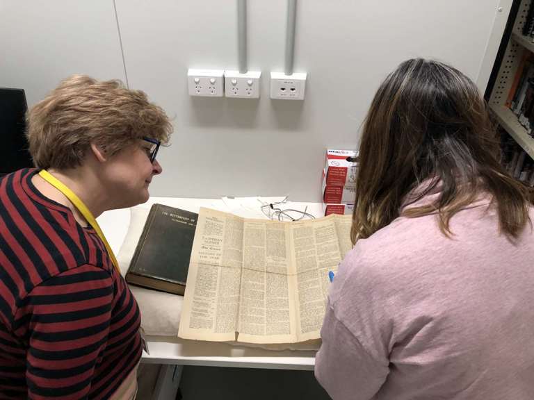Two women reading a book
