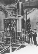 Original Thompson & Co. steam pumping engine with four Pumping Station workers clambering around it