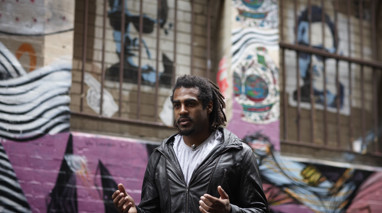 Man standing in the street with his hands out