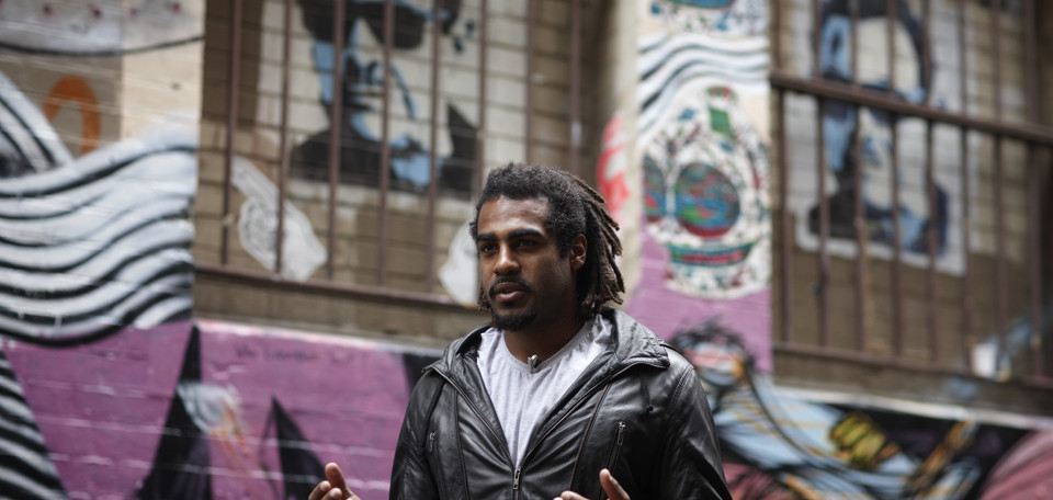 Man standing in the street with his hands out