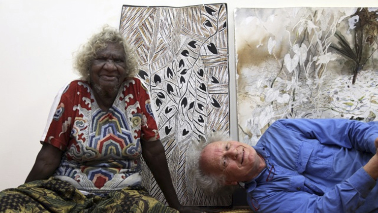 Artists Mulkuṉ Wirrpanda and John Wolseley pose in front of their work.
