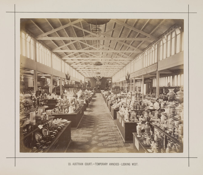 Interior view of a temporary annexe to the Royal Exhibition Building showing the Austrian display during the Melbourne International Exhibition of 1880. Caption reads: 23. Austrian Court.- Temporary Annexes.- Looking West