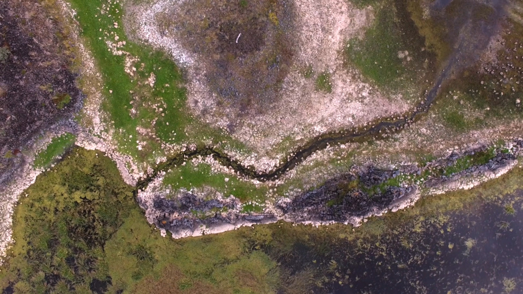 Water snakes through a stony and sodden landscape. 