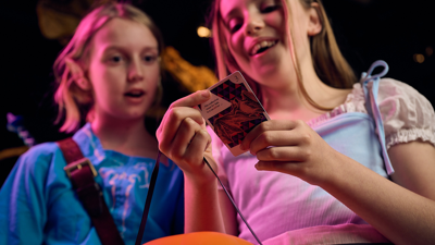 Two children collecting cards.