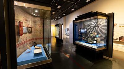 Display cabinets in  Voices Across Time exhibition at the Immigration Museum