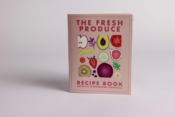 Recipe book with pink cover featuring illustrated fruits and vegetables.