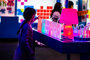 A child playing with light at the exhibition, Illuminate.
