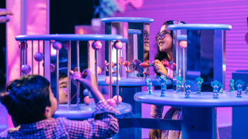 Two children playing in Illuminate How Science Comes To Light Exhibition.