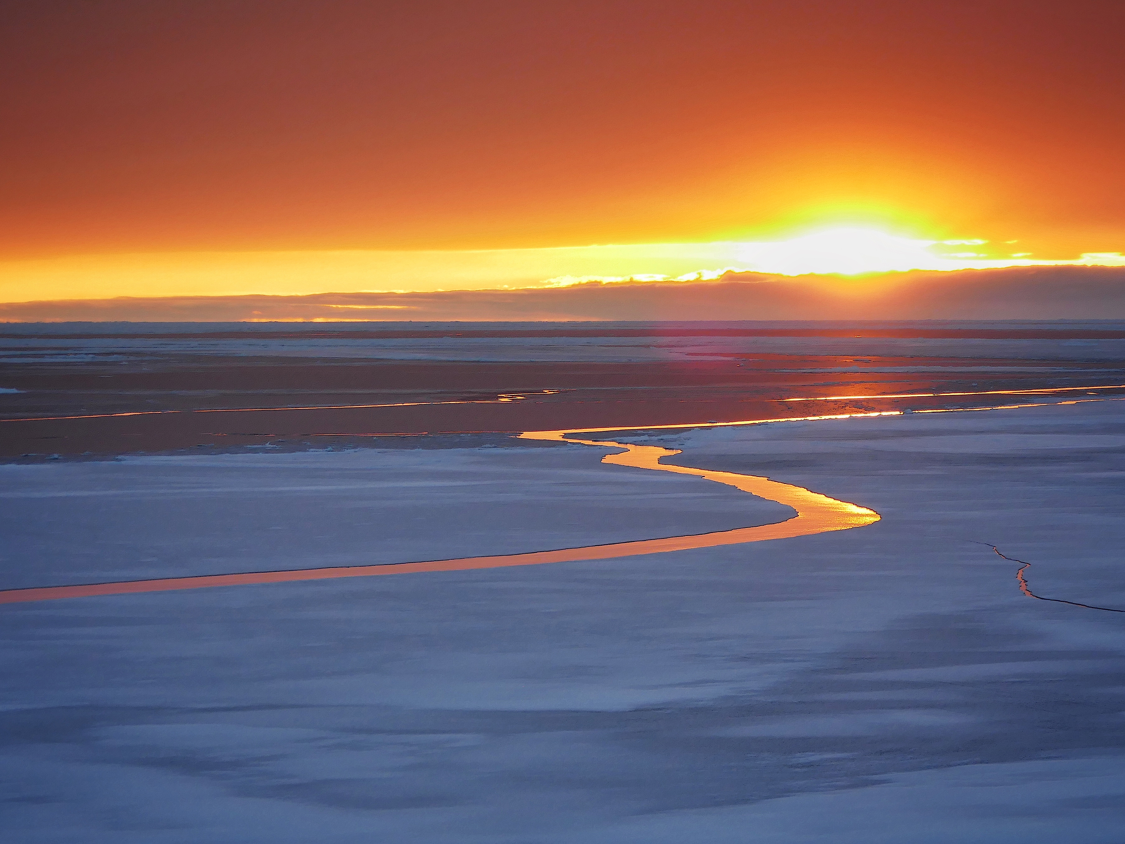 Sunset reflected in sea ice crack, near Casey Station, Antarctica