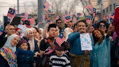 People waving Malaysian flags
