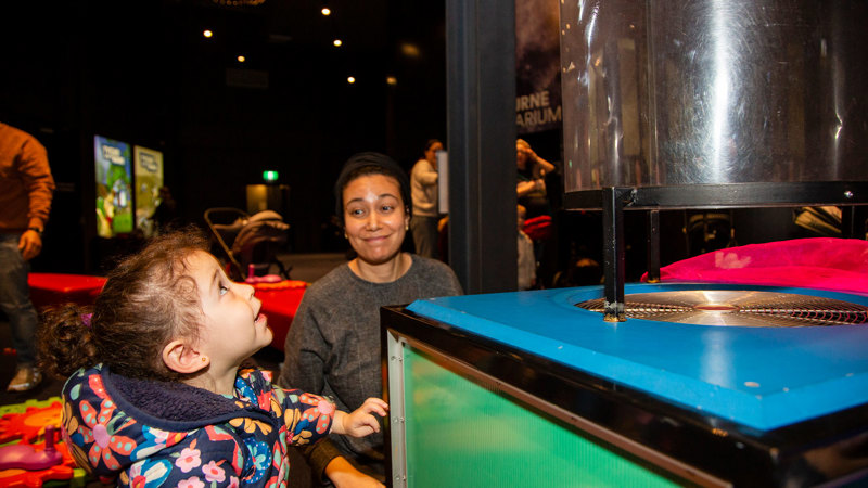 A child and guardian enjoying the Tiny Tinkerers Activity in the Planetarium Foyer, during the Little Kids Day In - Caring for Country program 