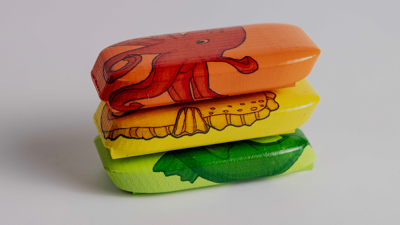 Stack of three flotational devices in orange, yellow and green.