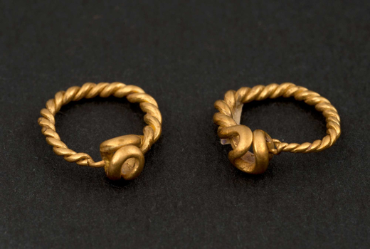 Gold pair of roman earrings