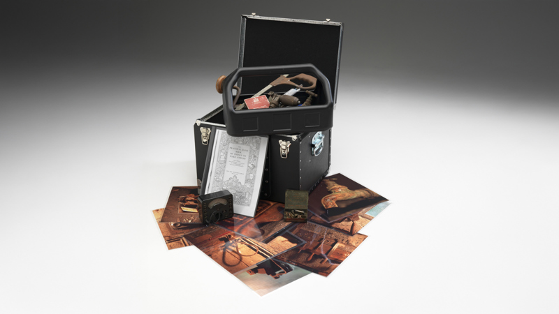 Box of hand tools with supporting pictures used in outreach programs 
