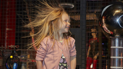 Girl participating in What's with the Weather activities in Lightning Room at Little Kids Day In event in Scienceworks.