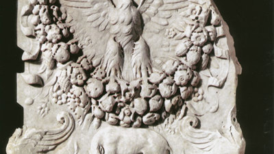 Stone altar featuring Romulus and Remus suckling a wolf.