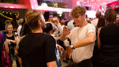 Two men dancing together at Melbourne Museum.