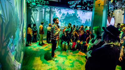 A man gives a talk in the Triceratops exhibition.