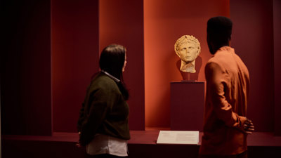 Visitors viewing a roman bust ROME: Empire, Power, People exhibition in Melbourne Museum.