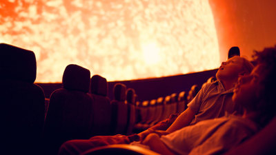 Secondary school students observes a projection of the Sun on the dome of the Melbourne Planetarium.