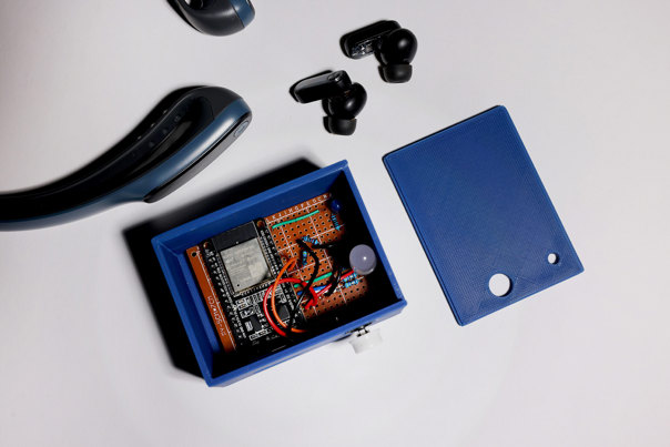 Low, rectangular sideboard in dark-stained timber with four polished-brass disc handles, three storage compartments with sliding doors, and slender squared legs.