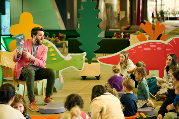 Children being read to at Dino Days.