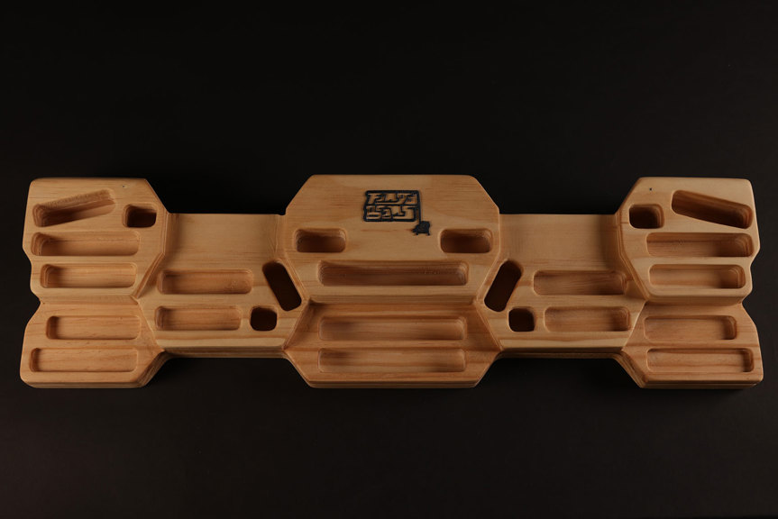 Geometric wooden model with several rectangular recesses.