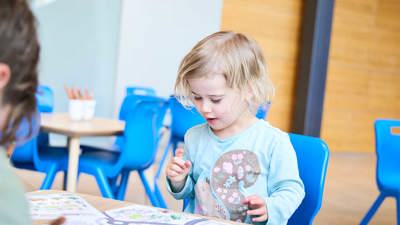 Childr with craft materials and road maps at the activity, lower ground floor outside the Learning studios.