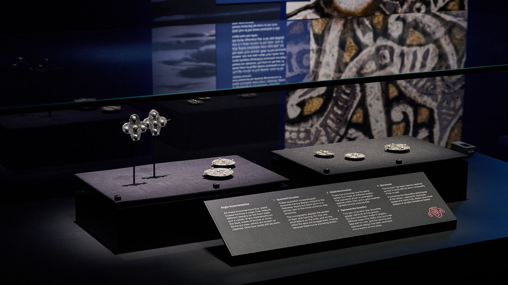 Galloway Hoard artefacts on display, showing metalwork pieces in display case against a dark background