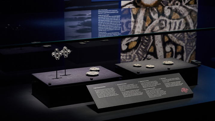 Galloway Hoard artefacts on display, showing metalwork pieces in display case against a dark background