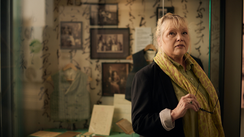 A woman looks at displays in Voices Across Time exhibition in the Immigration Museum.