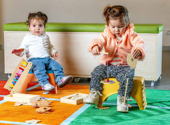 Children playing with early learning toys.