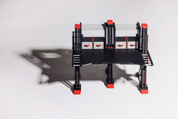 Black workbench with three A-frame legs, four integrated storage drawers, and red accents.