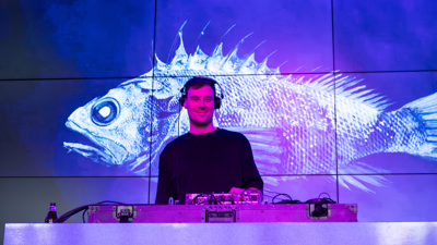 A DJ smiling for the camera at Nocturnal, Melbourne Museum.