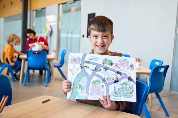 Children with craft materials and road maps at the activity, lower ground floor outside the Learning studios.