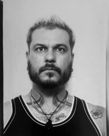 Headshot of J Davies.