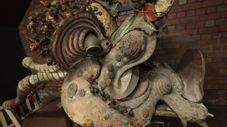 the head of a Chinese dragon resting on a plinth