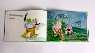 Open hardback book featuring text and cartoon illustrations of the characters Little Frog and Tiny Mouse.